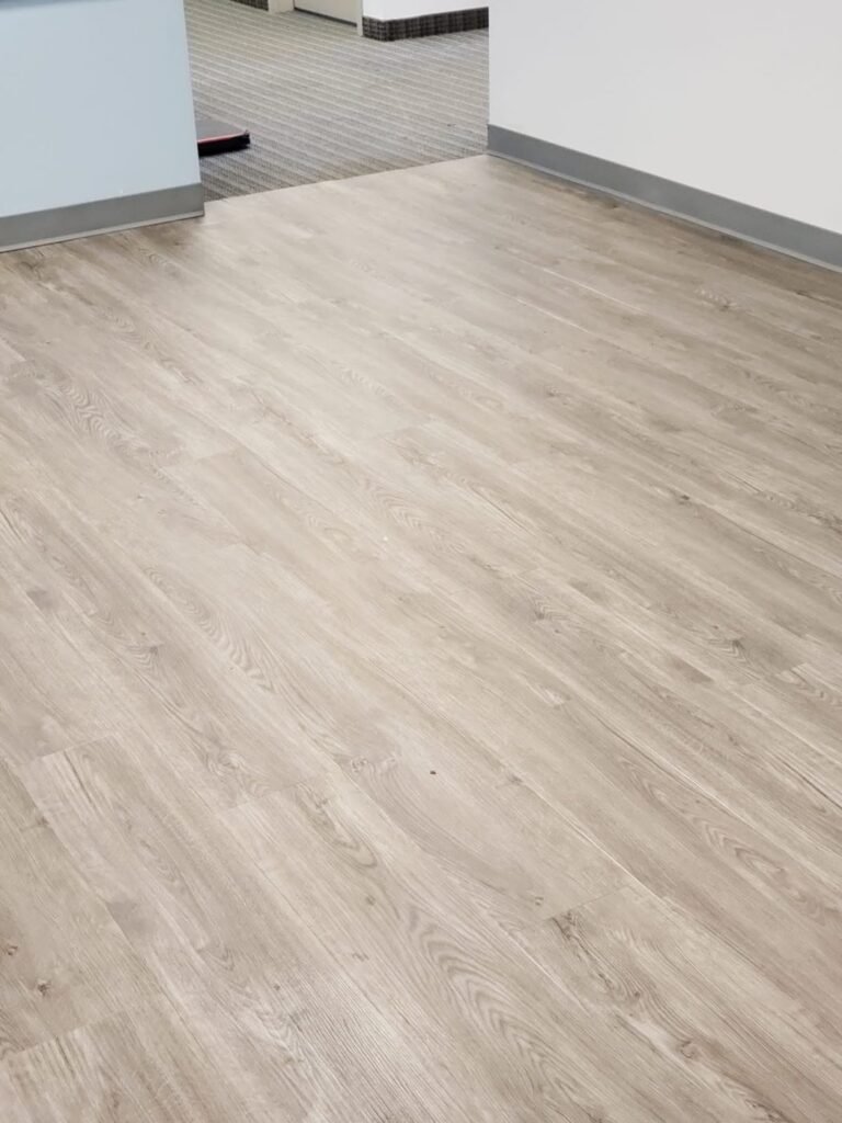Empty room with new light wood-look flooring - Pi Floor & Blinds Victoria BC